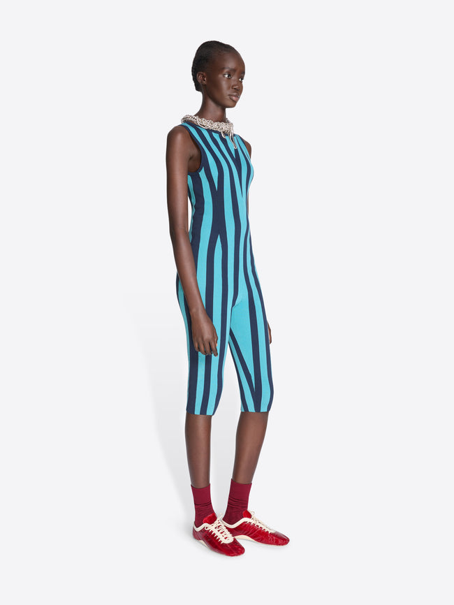 Model wearing a blue and black striped dress with red shoes on a white background - Dries Van Noten