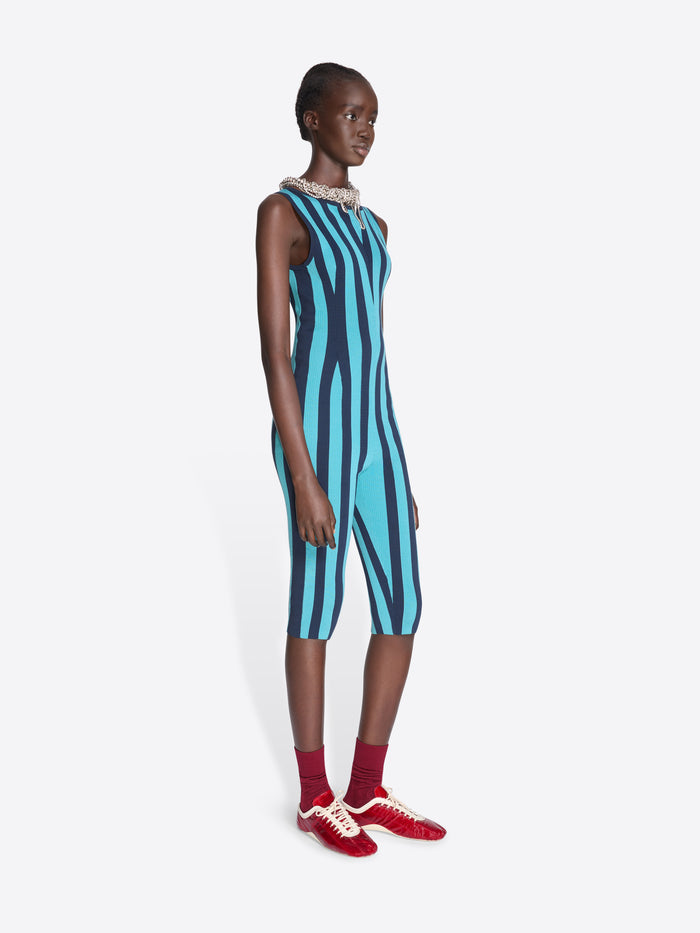 Model wearing a blue and black striped dress with red shoes on a white background - Dries Van Noten