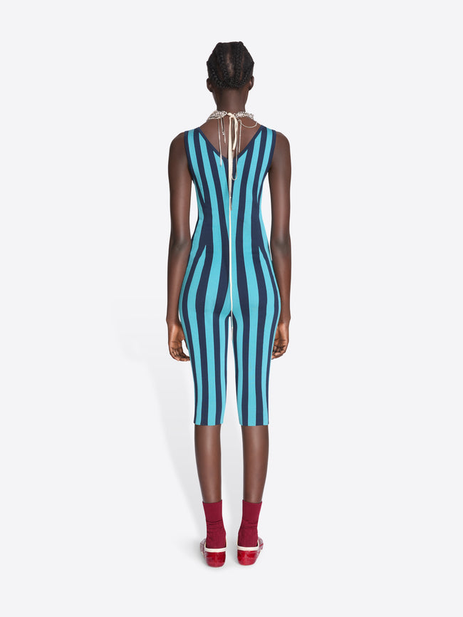 Model wearing a blue and black striped jumpsuit on a white background - Dries Van Noten