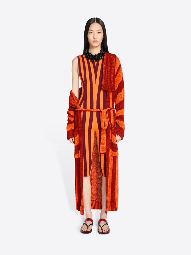 Model wearing a red and orange striped dress with matching cardigan on a white background - Dries Van Noten