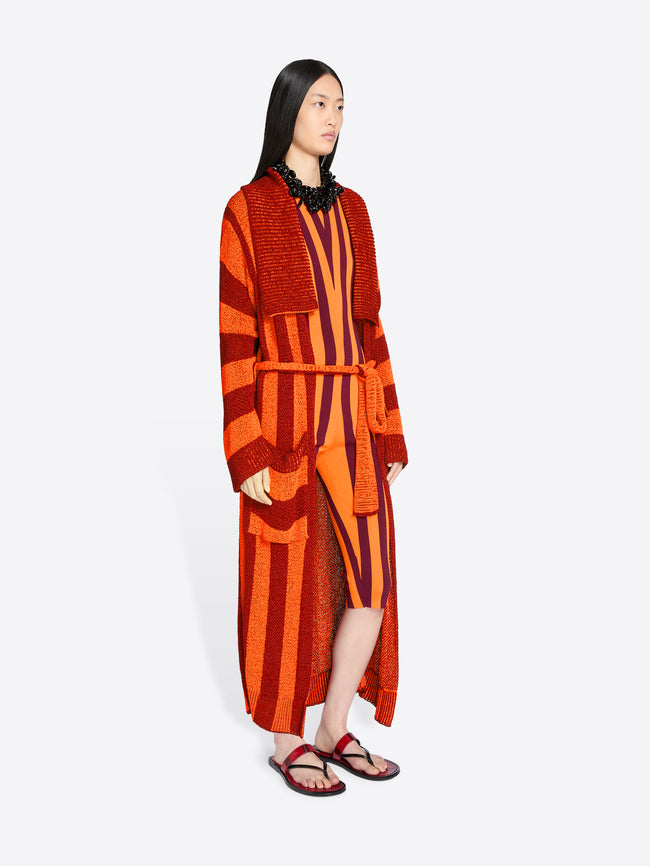 Woman wearing a red and orange striped outfit on a white background - Dries Van Noten