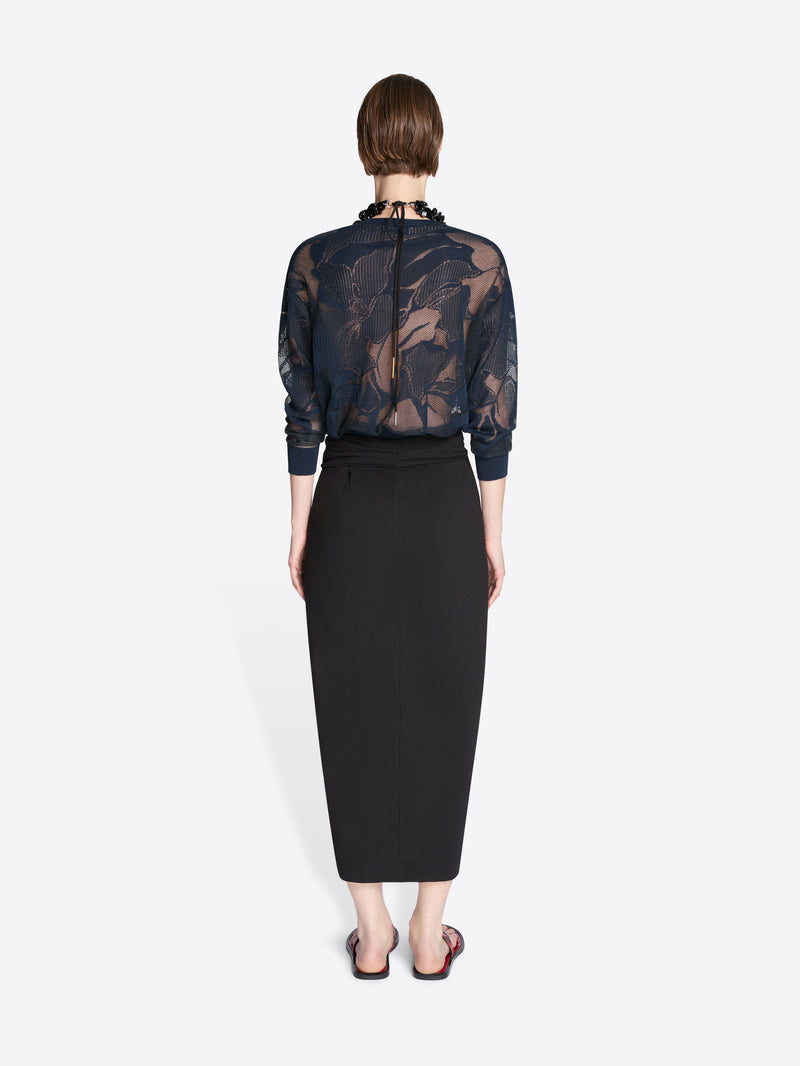 Person wearing a sheer black floral blouse with a black pencil skirt on a white background - Dries Van Noten