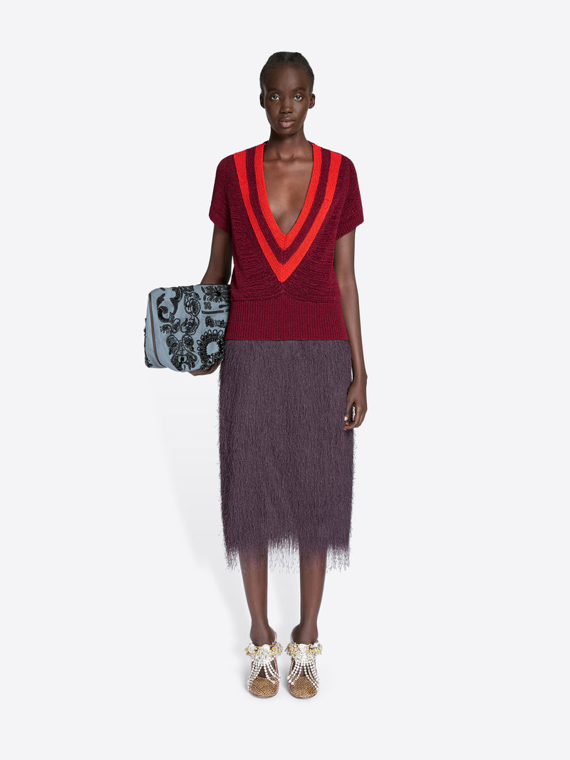 Model wearing a red and black outfit with a white background - Dries Van Noten