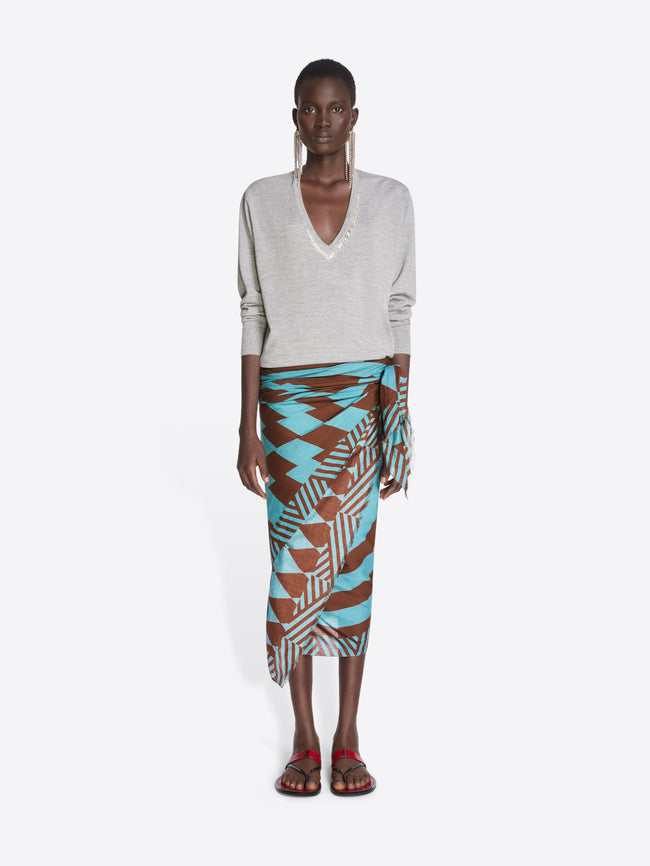 Model wearing a patterned skirt and light-colored top on a white background - Dries Van Noten
