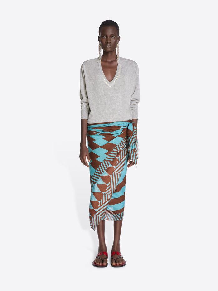 Model wearing a patterned skirt and light-colored top on a white background - Dries Van Noten