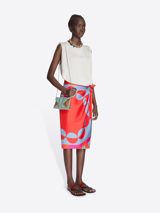 Woman wearing a white top and colorful skirt with a white background - Dries Van Noten