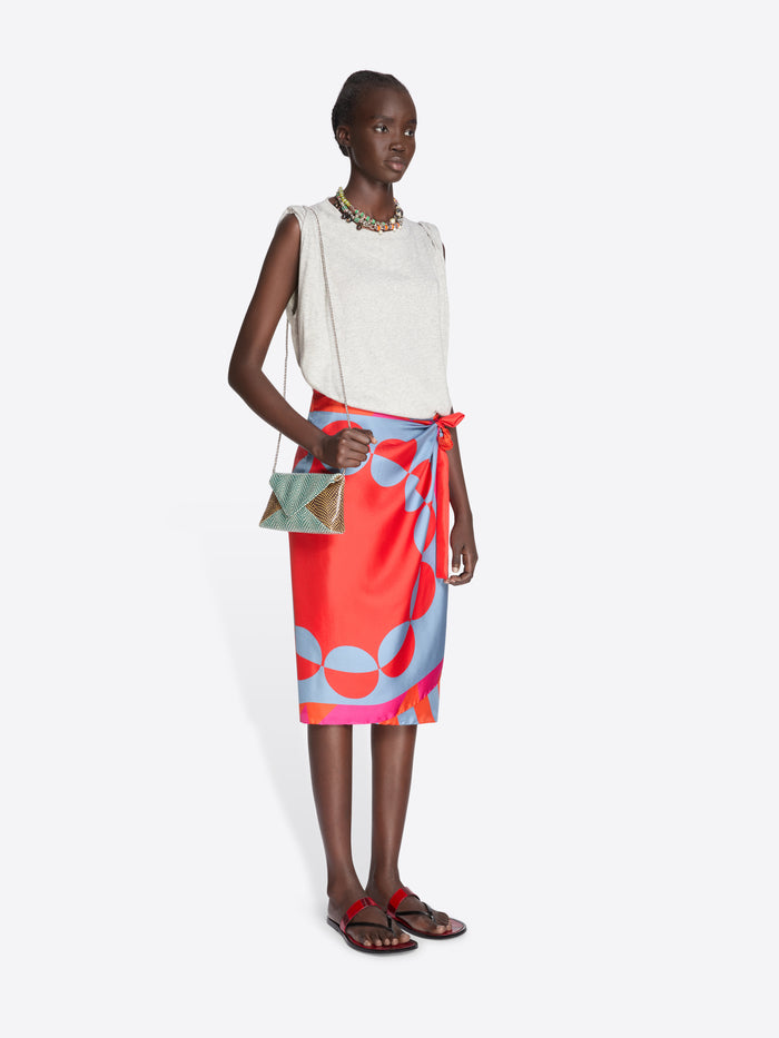 Woman wearing a white top and colorful skirt with a white background - Dries Van Noten