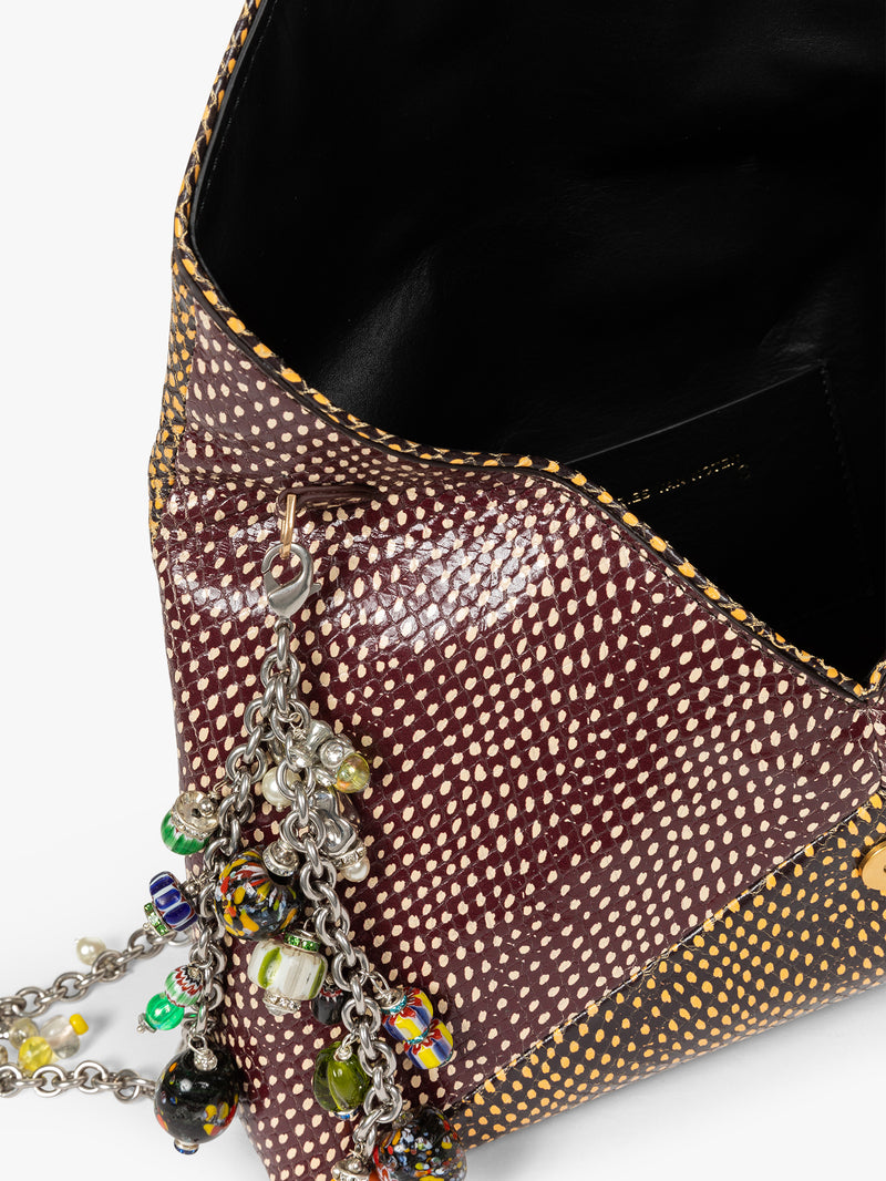 Close-up of a brown textured handbag with colorful charm chain on a white background - Dries Van Noten