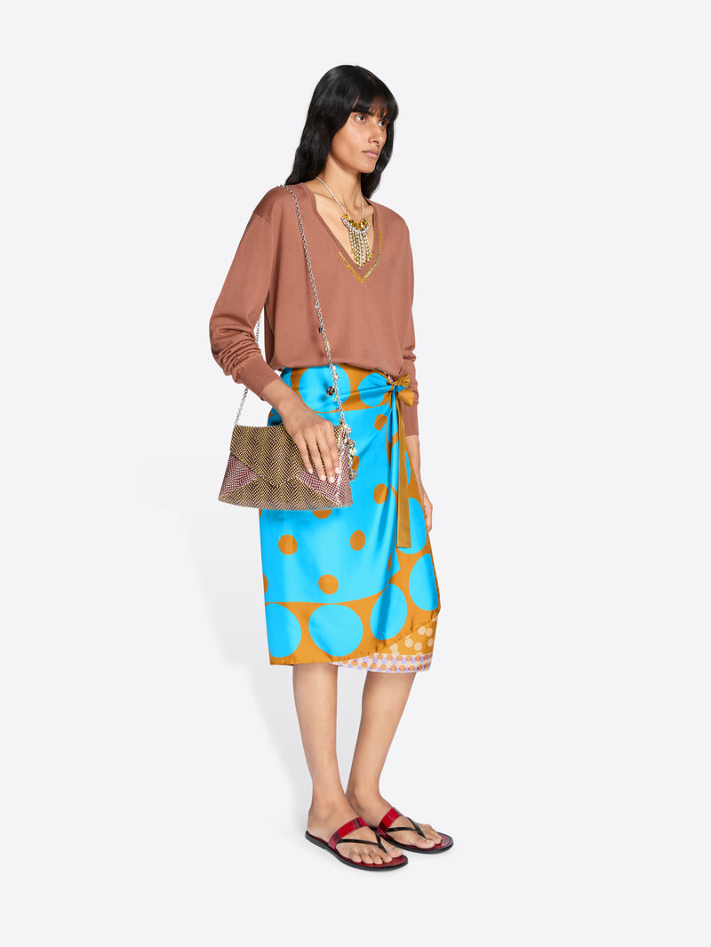 Woman wearing a brown top and blue floral skirt with a white background - Dries Van Noten