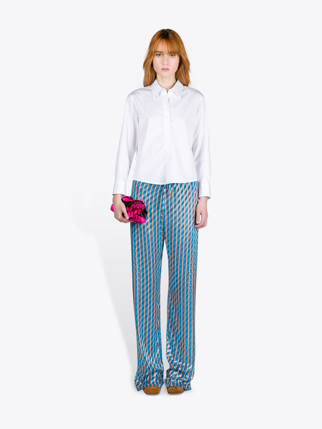 Woman wearing a white shirt and blue striped pants on a white background - Dries Van Noten