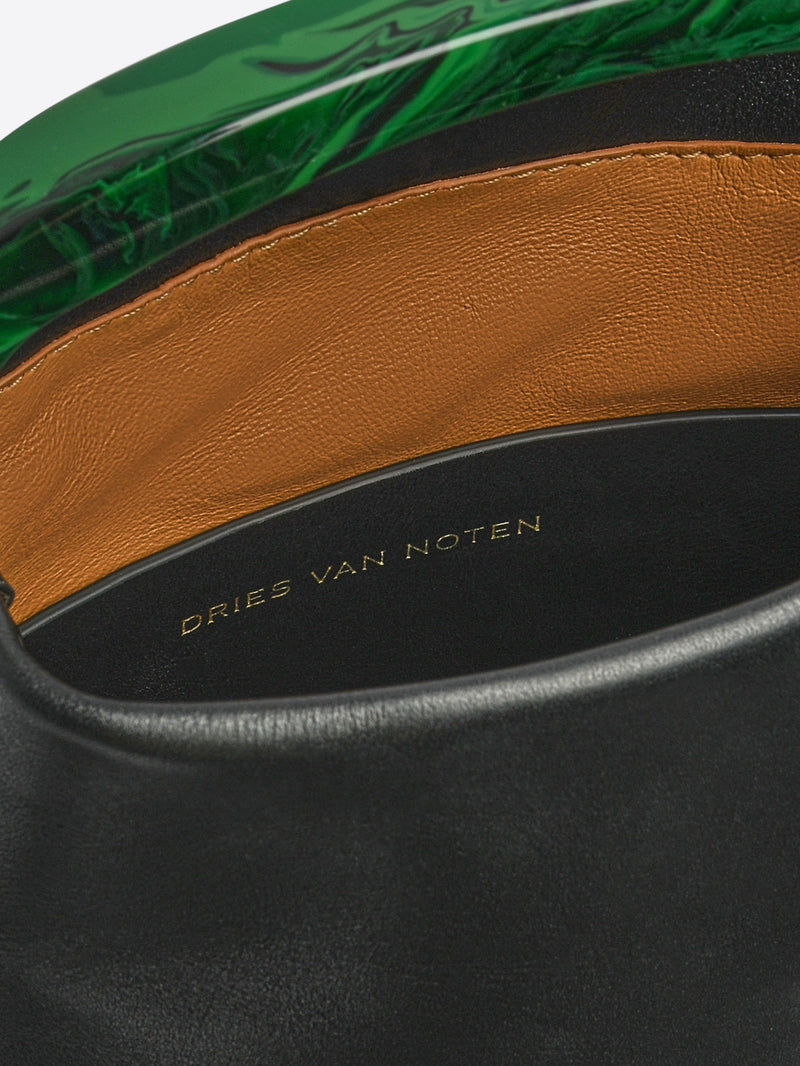 Close-up of a black leather handbag with brown and green accents, featuring the brand 'Dries Van Noten'.