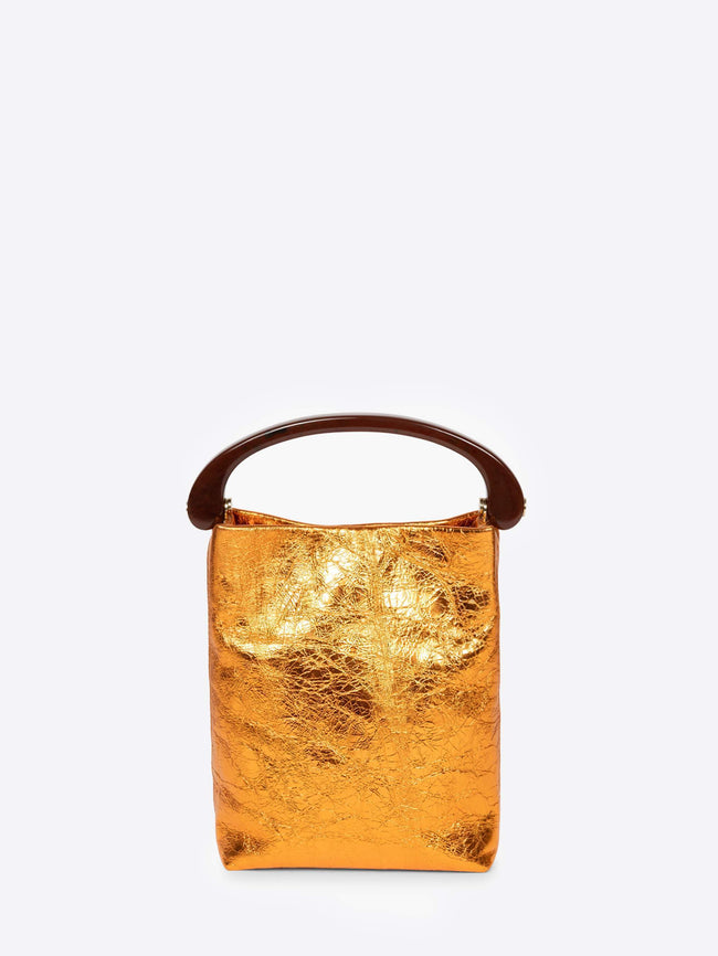 Gold metallic handbag with a brown handle on a white background