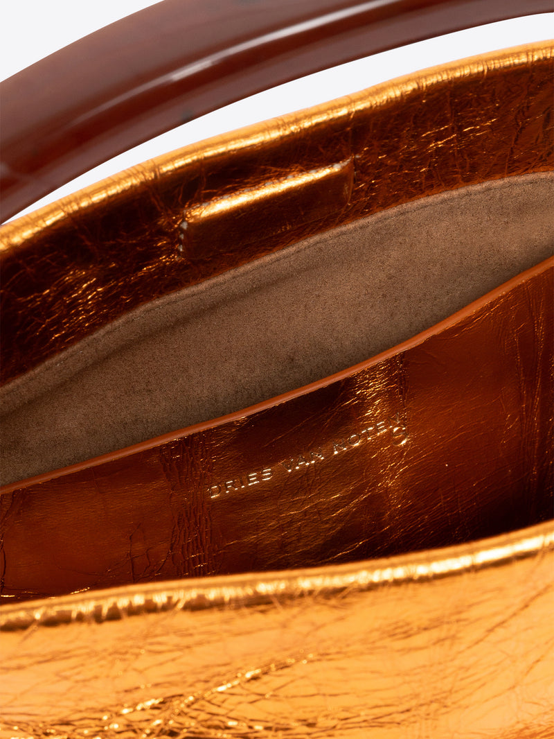 Close-up of a brown leather handbag with visible branding.