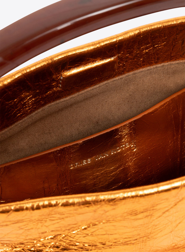 Close-up of a brown leather handbag with visible branding.