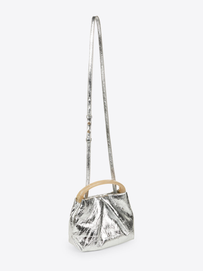 Silver metallic handbag with wooden handle on a white background