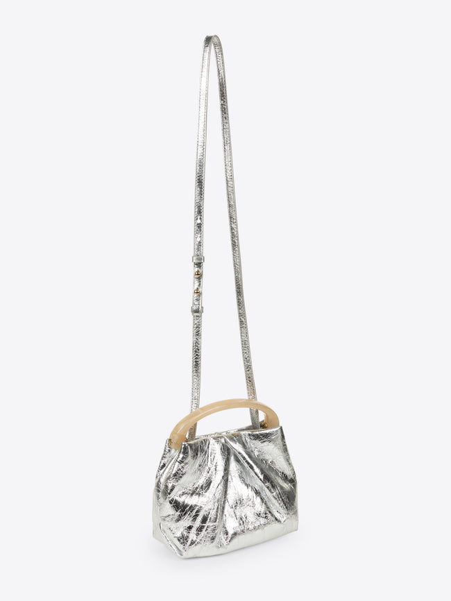 Silver metallic handbag with wooden handle on a white background