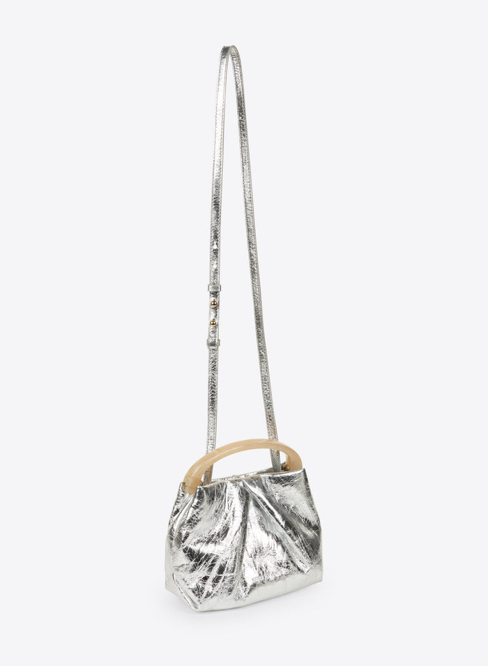 Silver metallic handbag with wooden handle on a white background