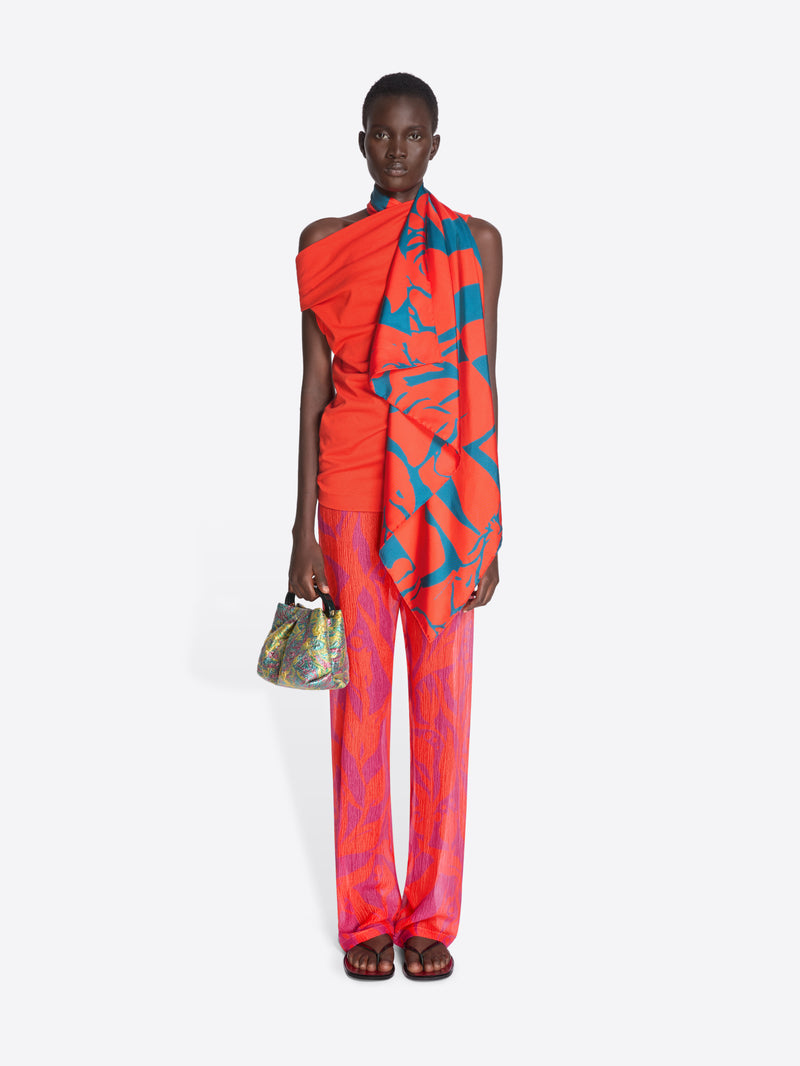 Model wearing a vibrant orange and blue patterned outfit on a white background - Dries Van Noten
