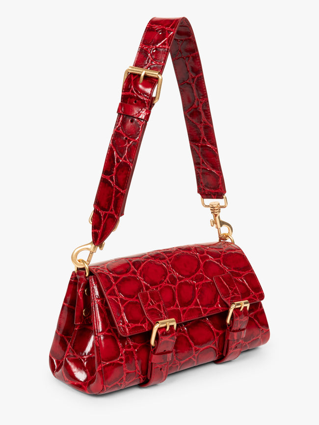 Red crocodile-patterned handbag with gold accents on a white background - Dries Van Noten