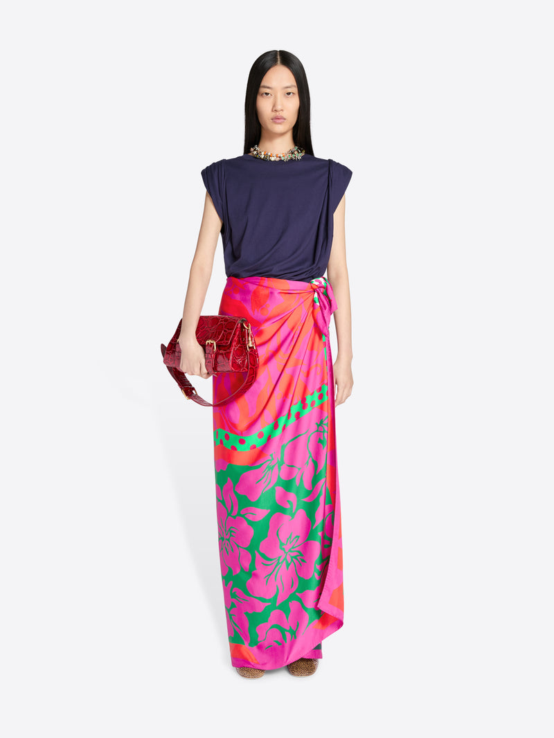 Model wearing a colorful floral skirt and navy top on a white background - Dries Van Noten