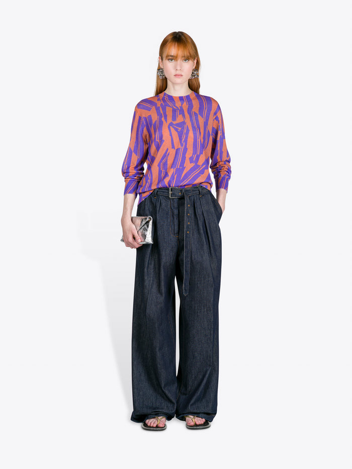 Person wearing a patterned top and wide-leg jeans on a white background - Dries Van Noten