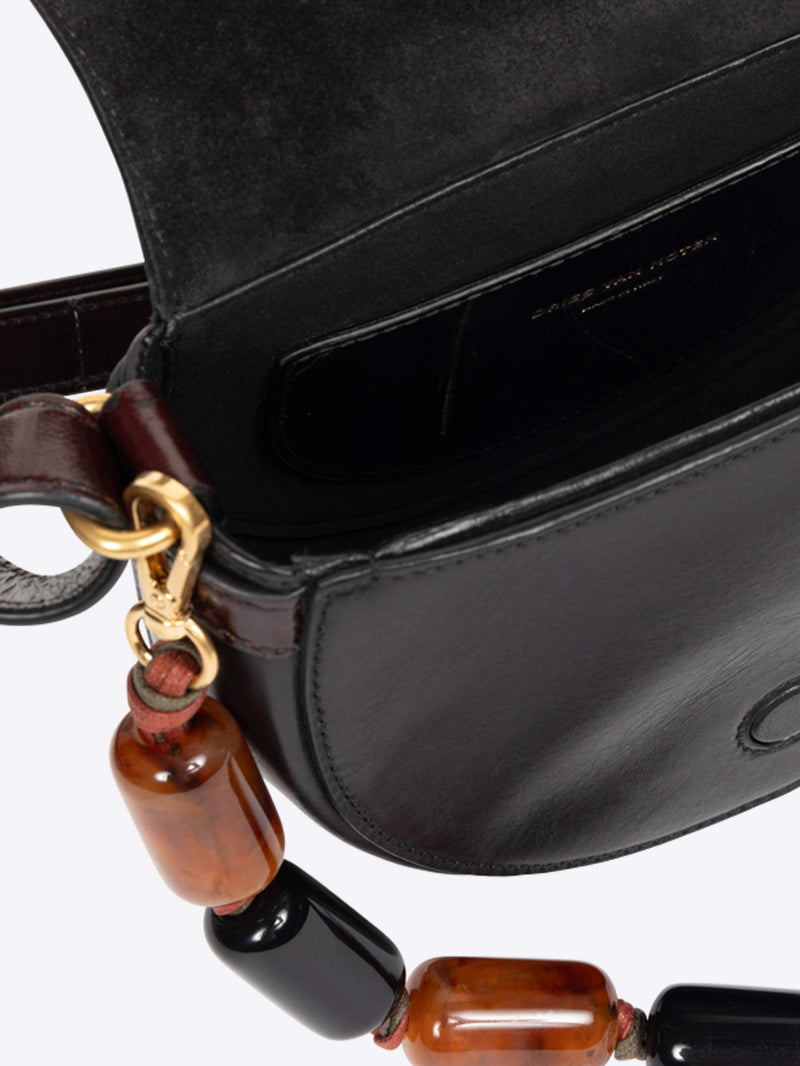 Close-up of a black handbag with a beaded strap on a white background - Dries Van Noten