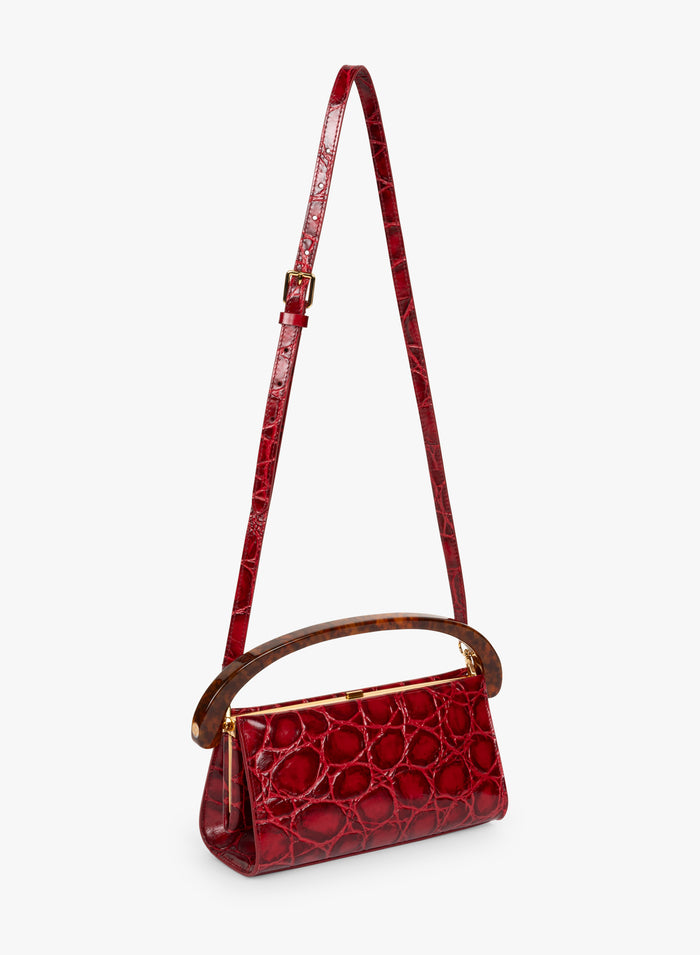 Red handbag with a strap on a white background - Dries Van Noten