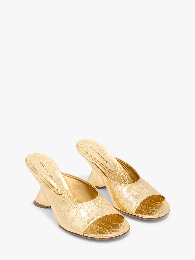 Pair of gold high-heeled shoes on a white background