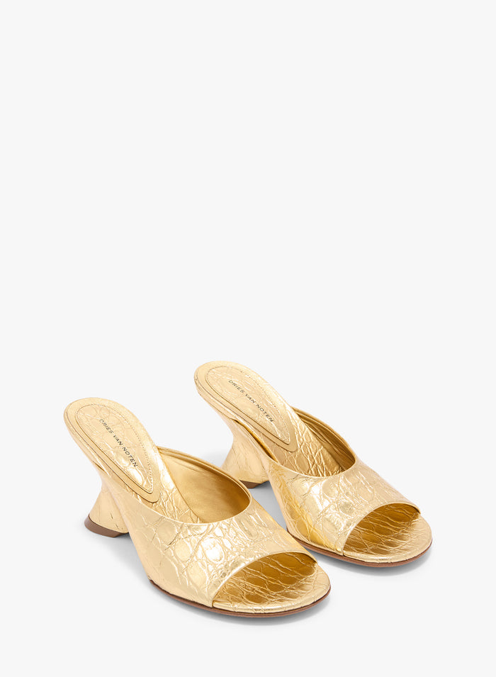 Pair of gold high-heeled shoes on a white background