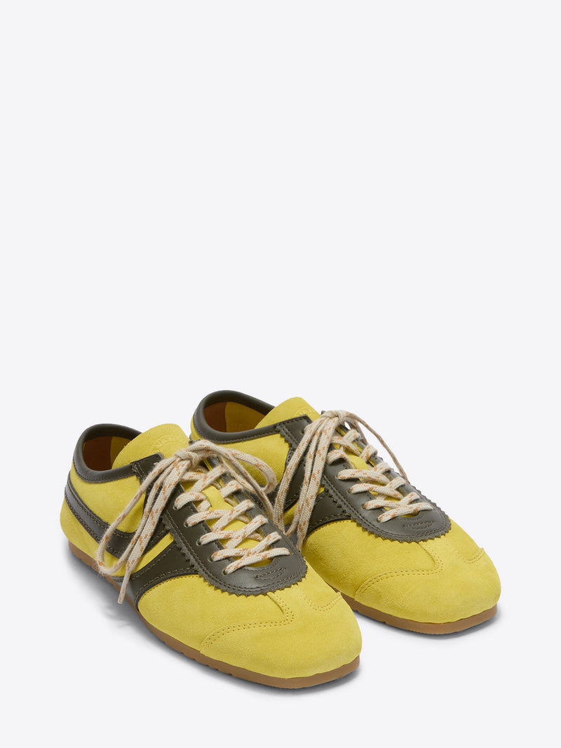 Pair of yellow and green sneakers on a white background