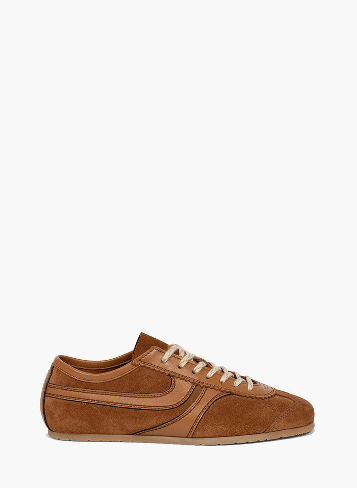 Brown sneaker with white laces on a white background