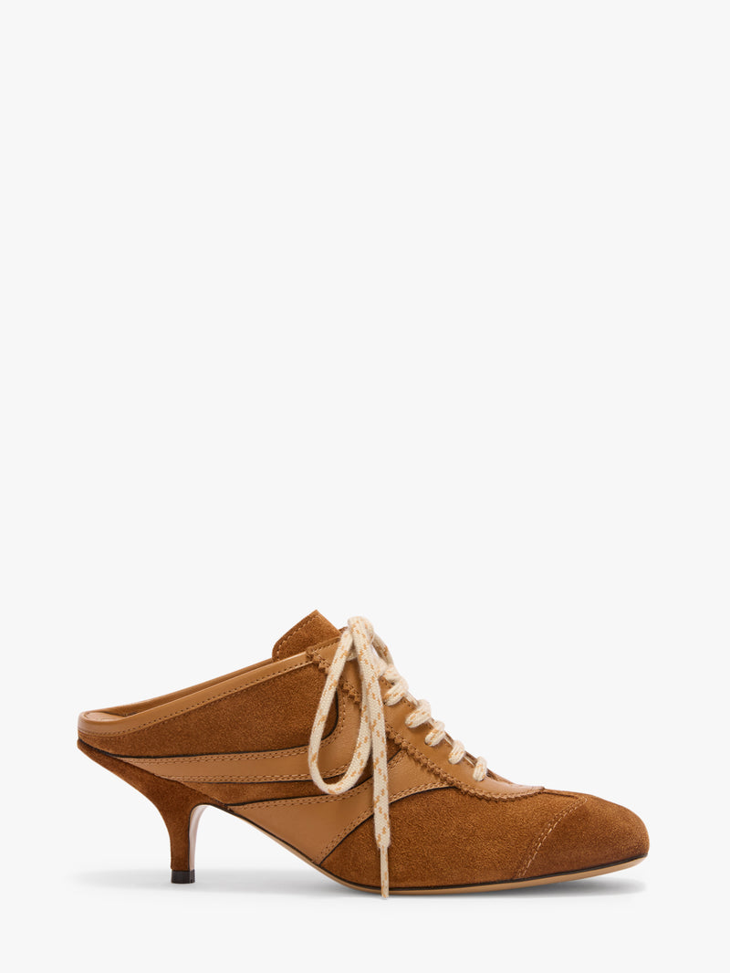 Brown high-heeled shoe with white laces on a white background