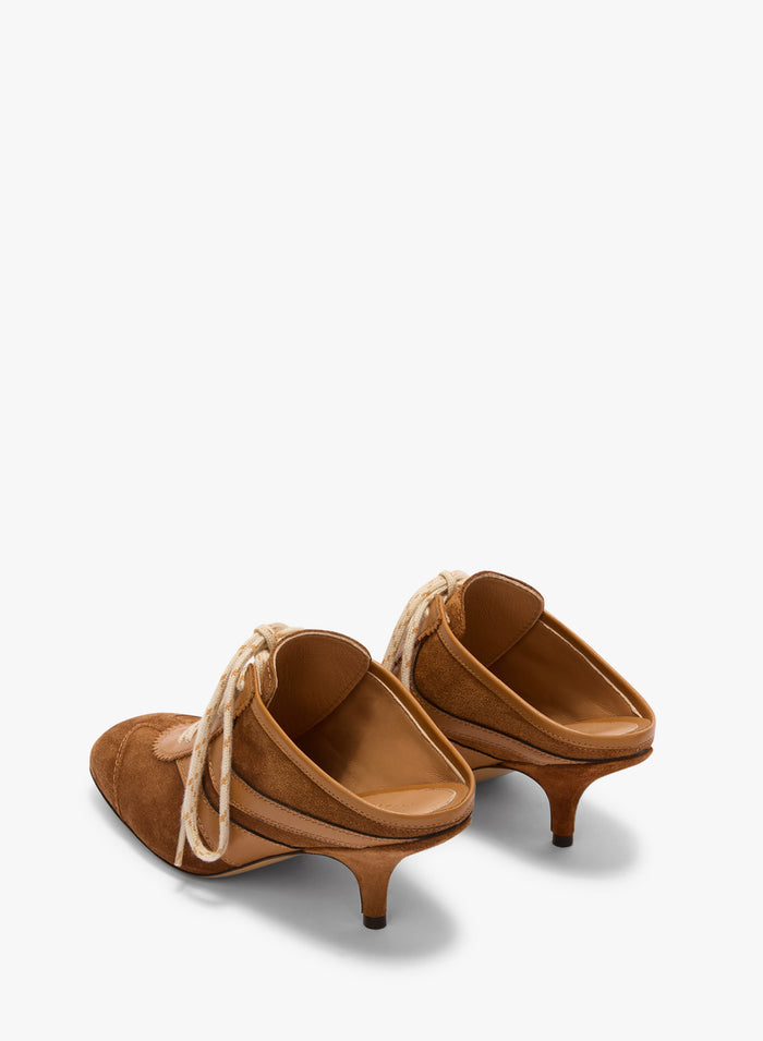 Pair of brown suede shoes with kitten heels on a white background