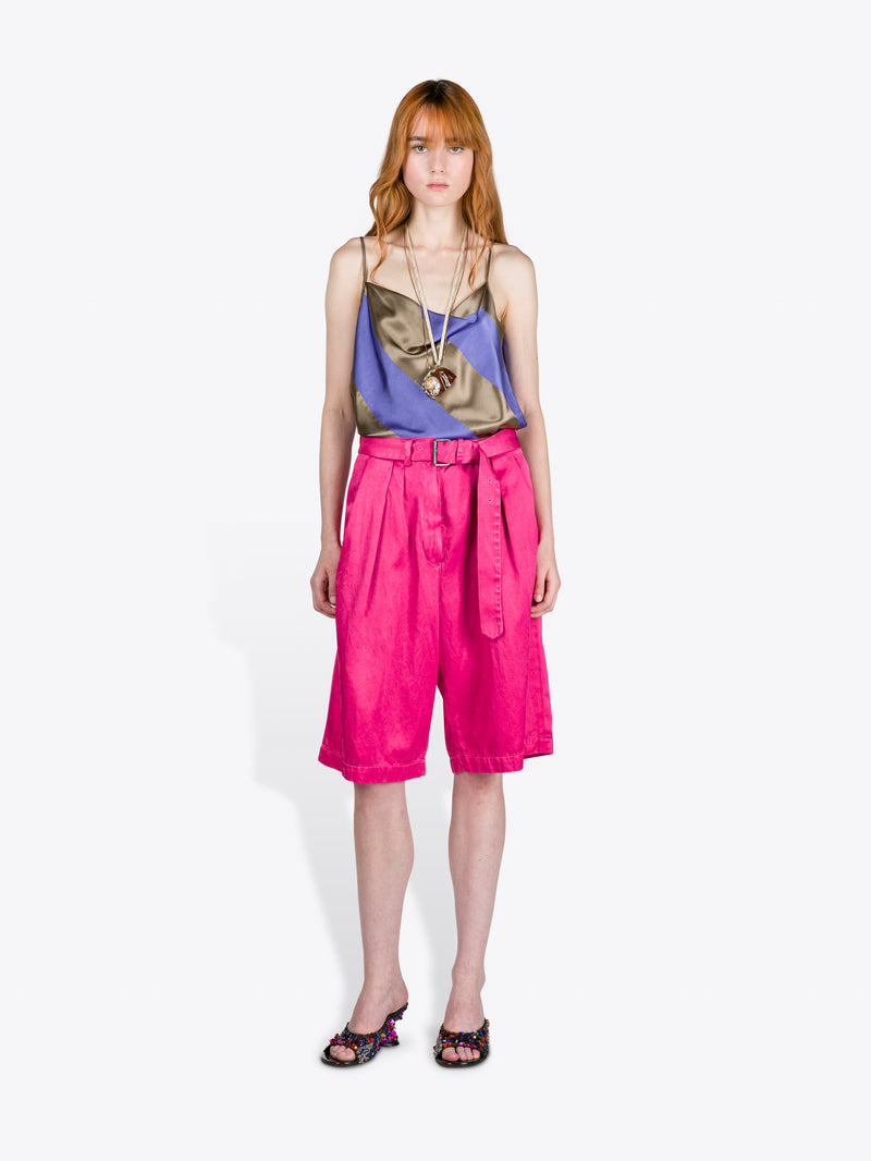 Woman wearing a colorful top and pink shorts on a white background - Dries Van Noten