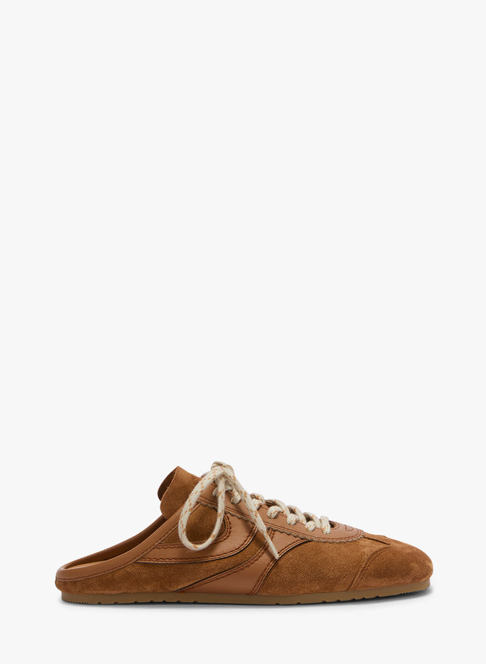 Brown suede shoe with white laces on a white background