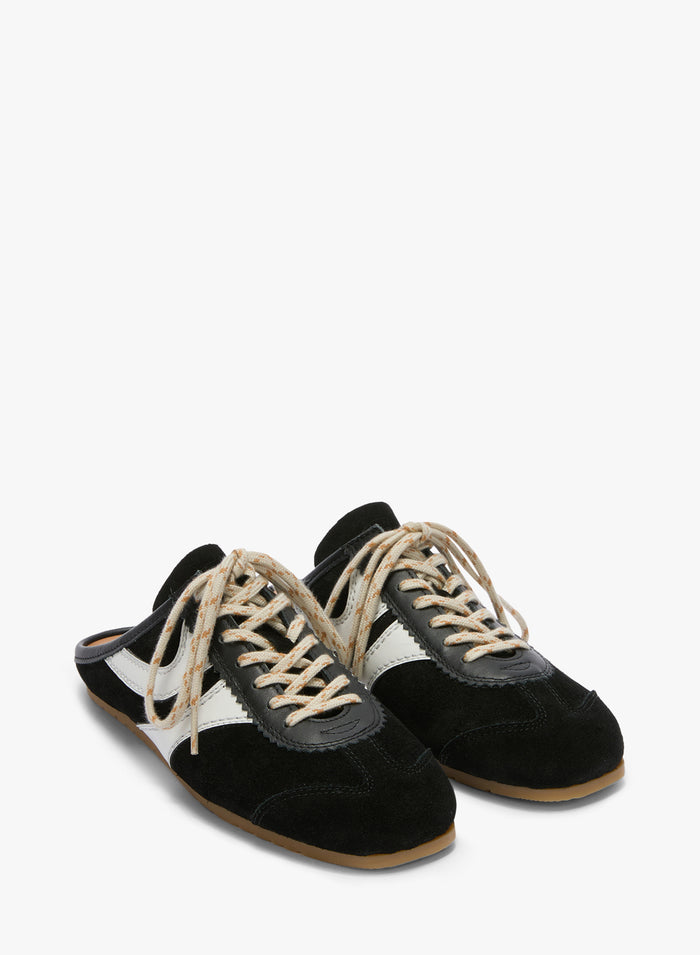 Pair of black and white sneakers with brown soles on a white background