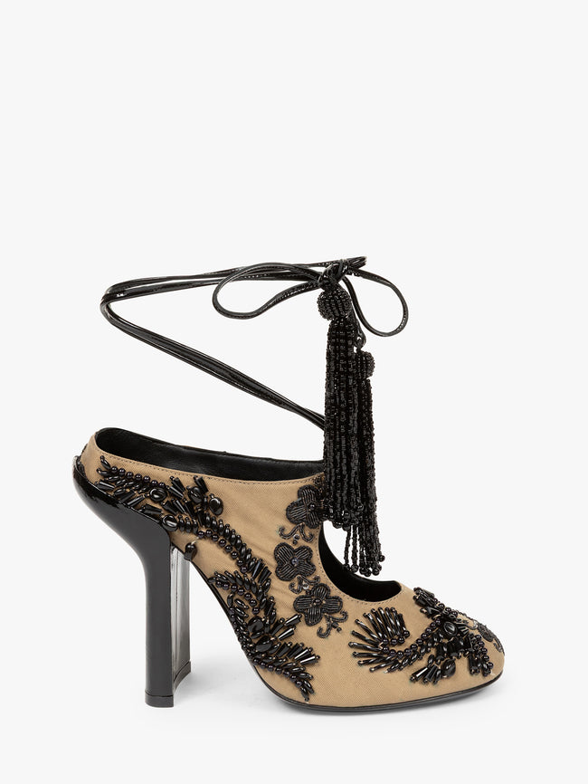 Beige high-heeled shoe with black lace and tassel design on a white background - Dries Van Noten