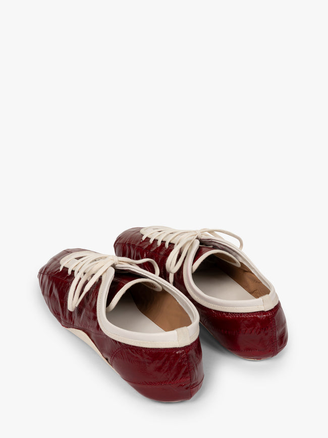 Pair of maroon shoes with white laces on a white background - Dries Van Noten