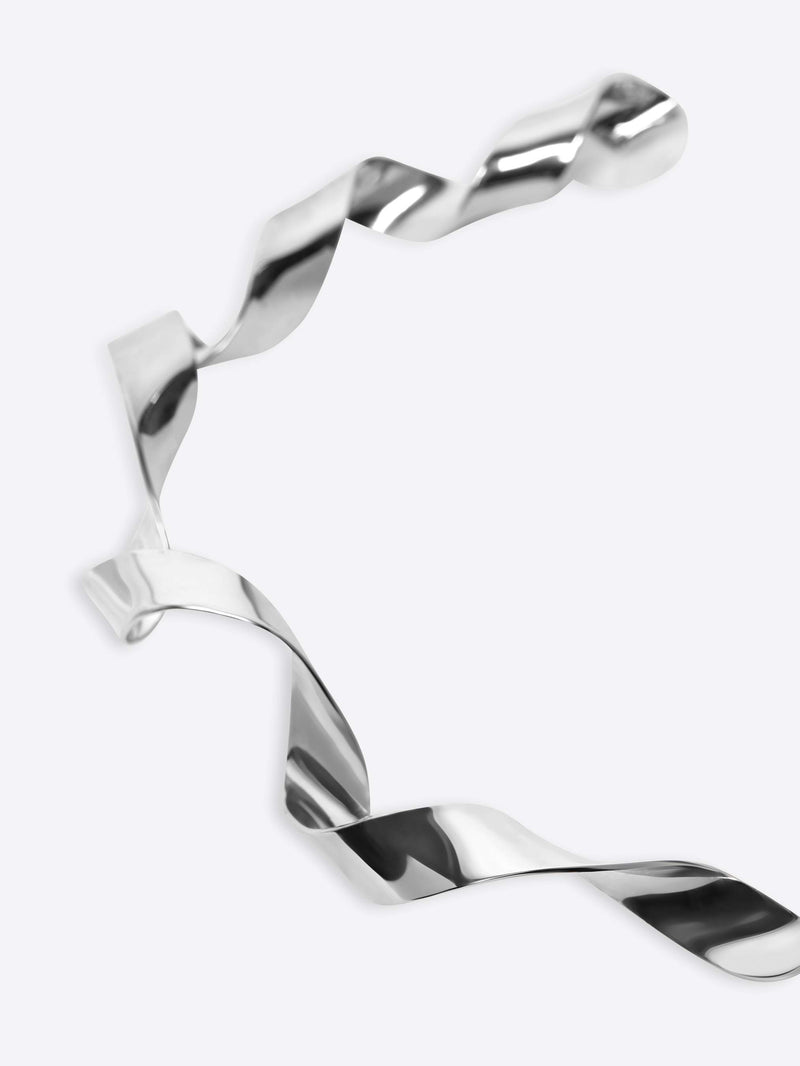 Silver bracelet with a twisted design on a white background - Dries Van Noten