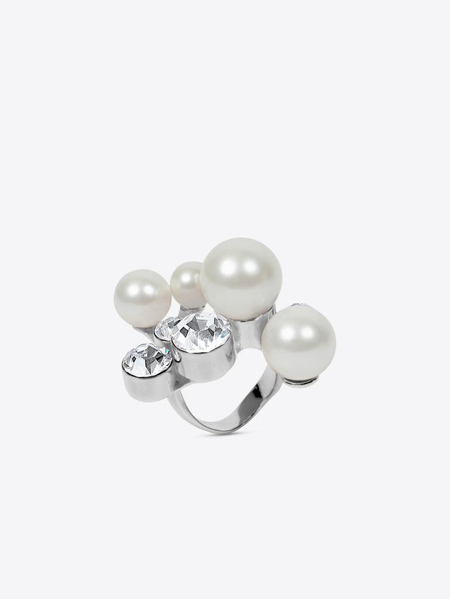 Ring with pearls and crystals on a white background