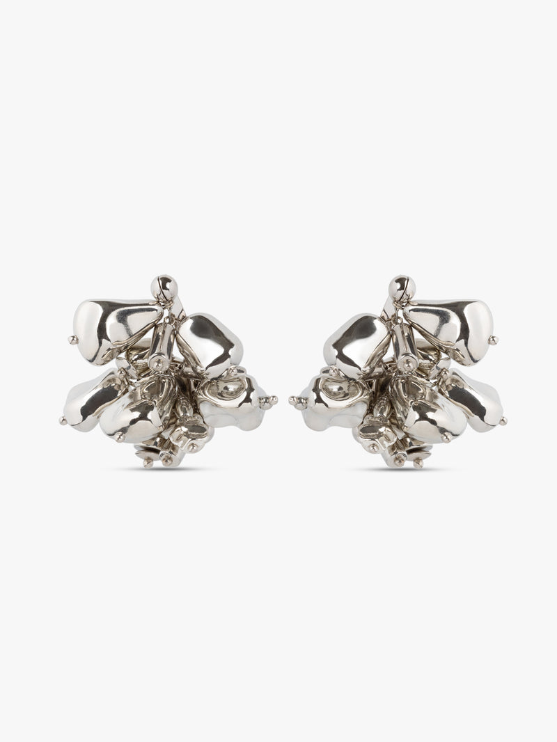 Pair of silver floral earrings on a white background
