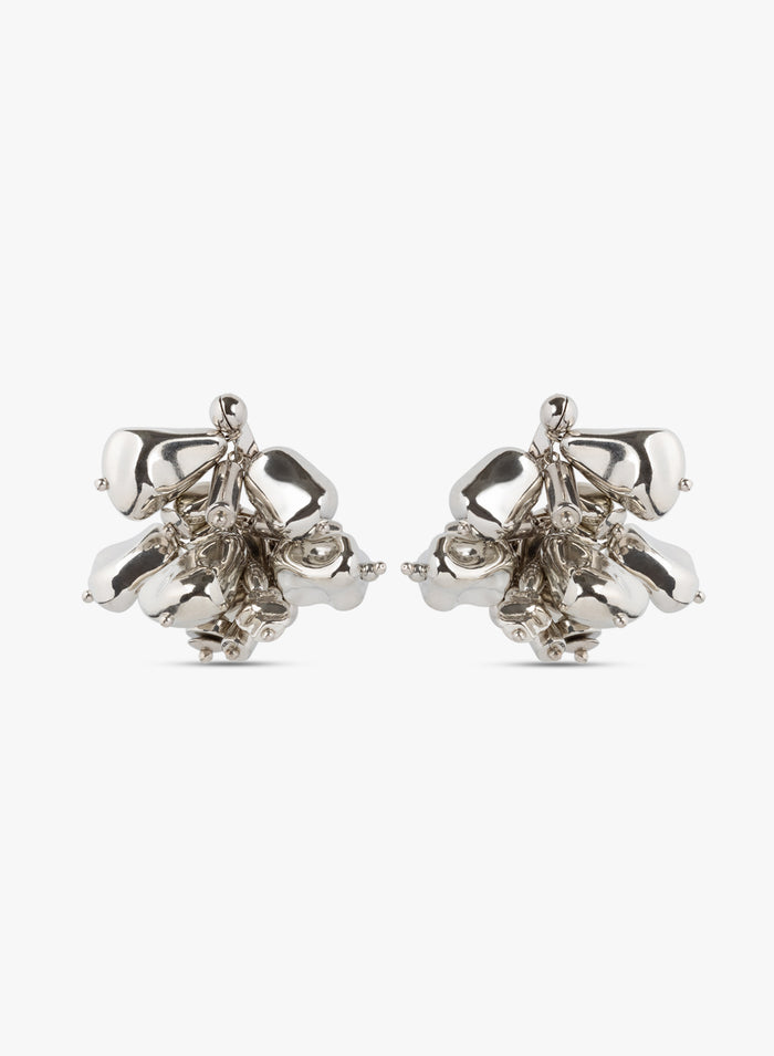 Pair of silver floral earrings on a white background