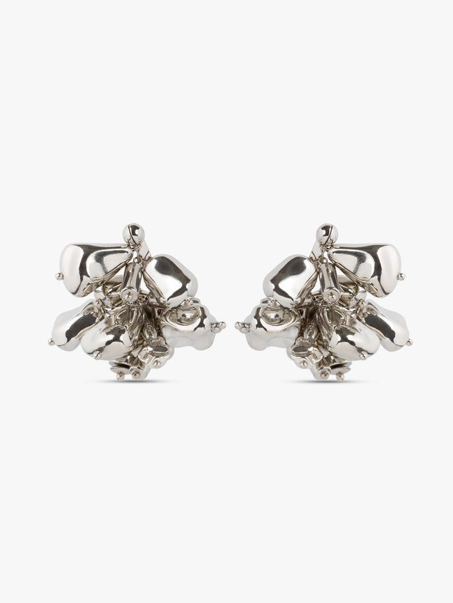 Pair of silver floral earrings on a white background