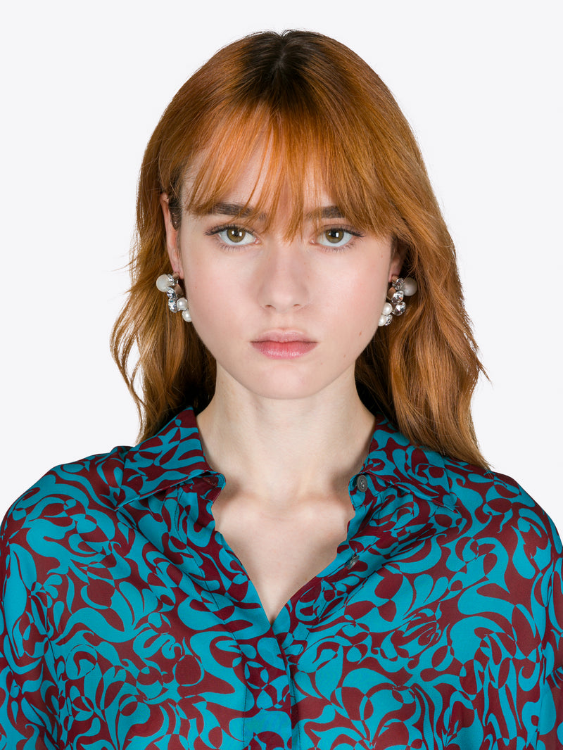 Woman wearing a blue and red patterned blouse with a plain background - Dries Van Noten