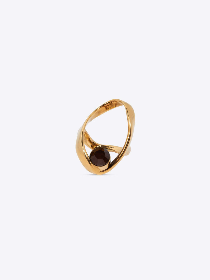 Gold ring with a dark gemstone on a white background