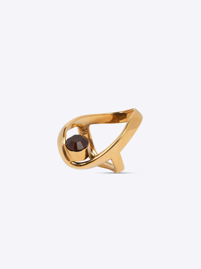 Gold ring with a dark gemstone on a white background