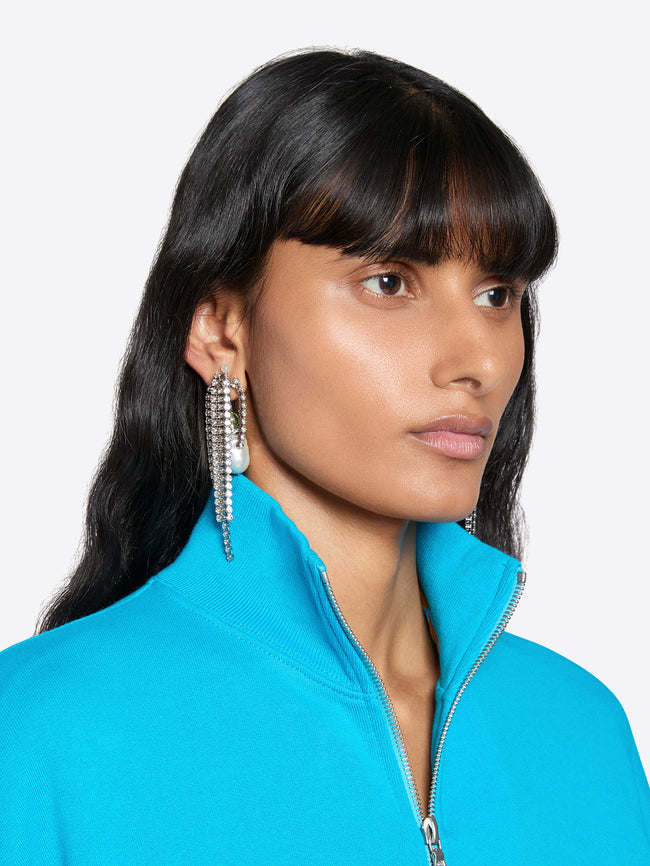 Woman wearing a turquoise jacket with a plain background - Dries Van Noten