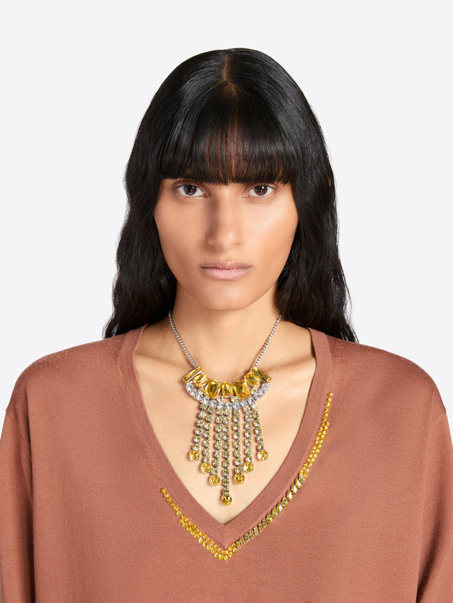 Woman wearing a brown top and a decorative necklace with yellow stones on a white background - Dries Van Noten