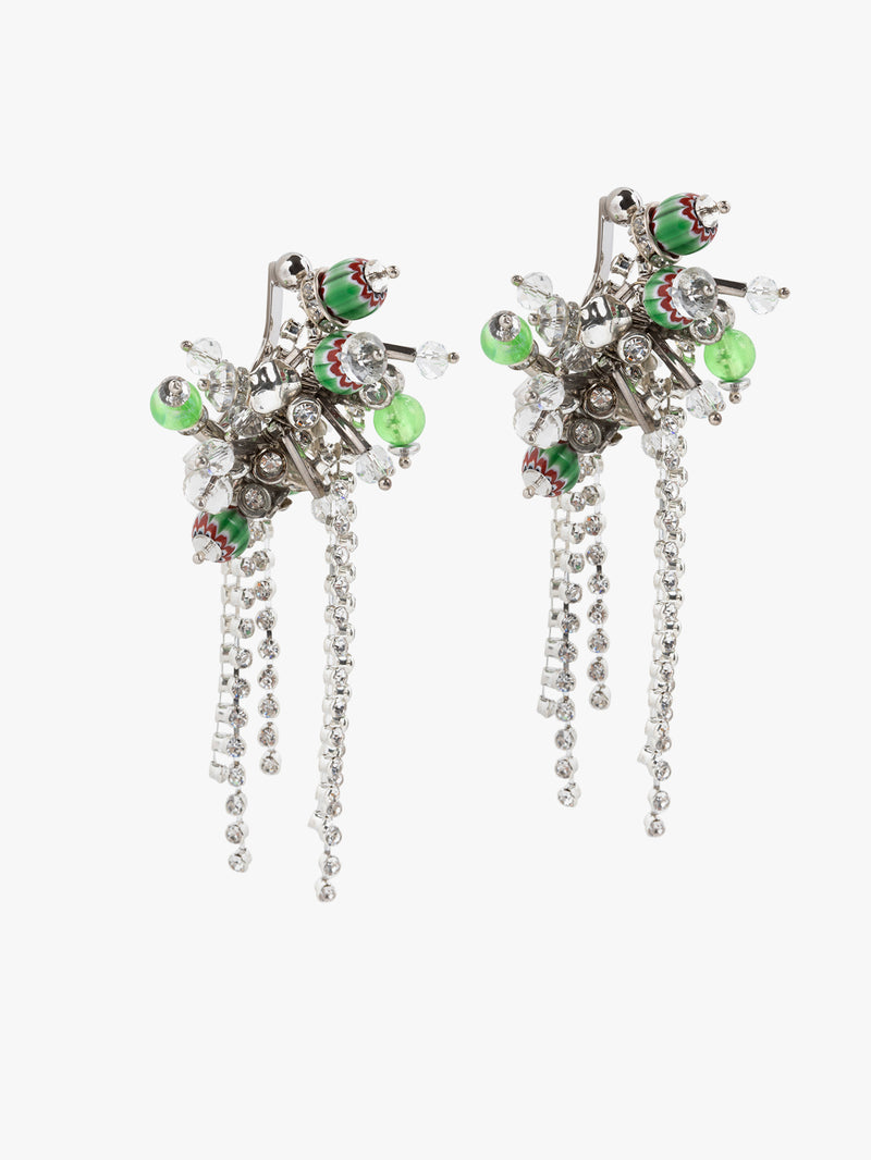Pair of ornate earrings with green and clear gemstones on a white background - Dries Van Noten
