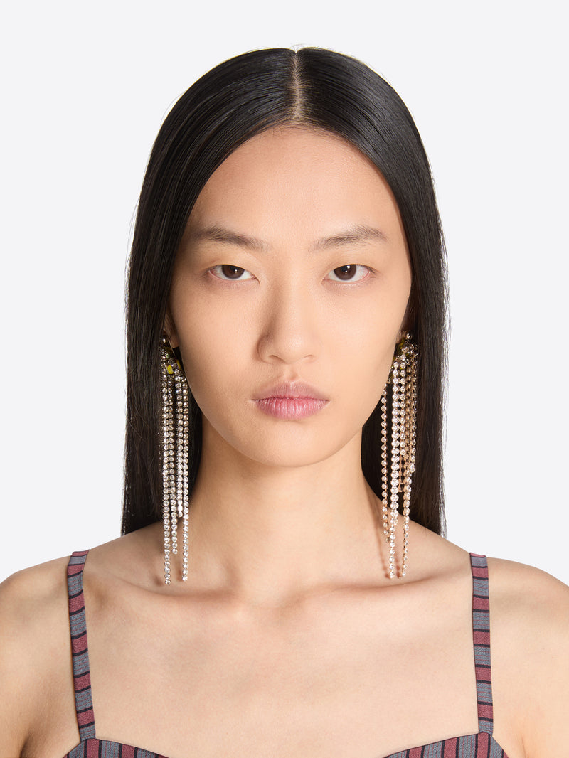 Woman wearing long pearl earrings against a white background - Dries Van Noten